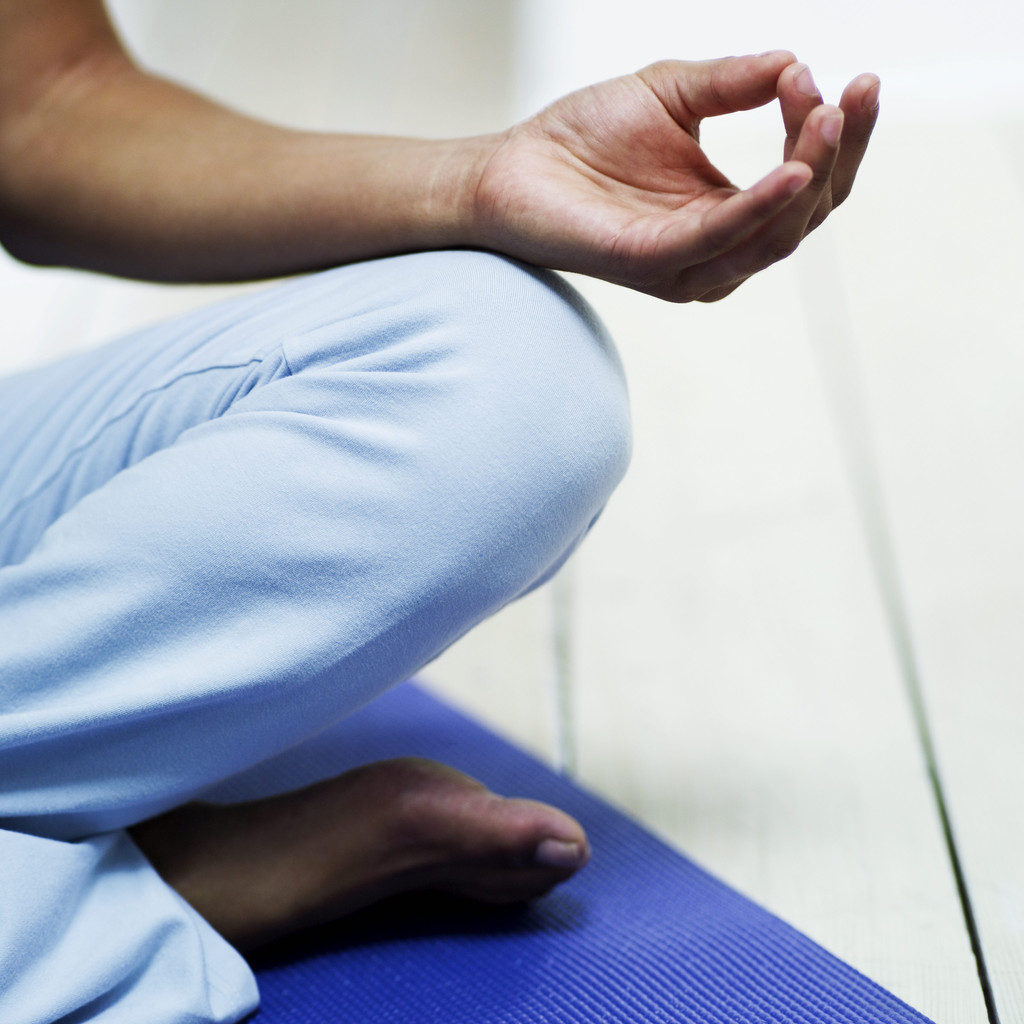 Young Woman Meditating on the Floor